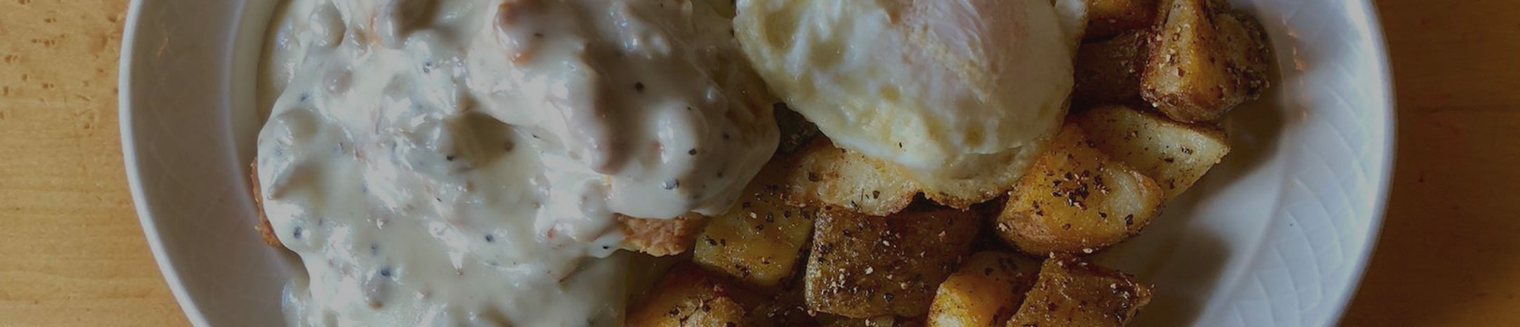 biscuits-and-gravy-_-BODEGA-Restaurant-Bar-Downtown-Marquette-Michigan-Breakfast-Lunch-Dinner-Beer-Wine-Cocktails-Music-Events-Open-Mic-Vegan-Organic-Vegetarian-Gluten-Free biscuits and gravy homemade made from scratch biscuits grilled potatoes fried egg local bodega marquette michigan